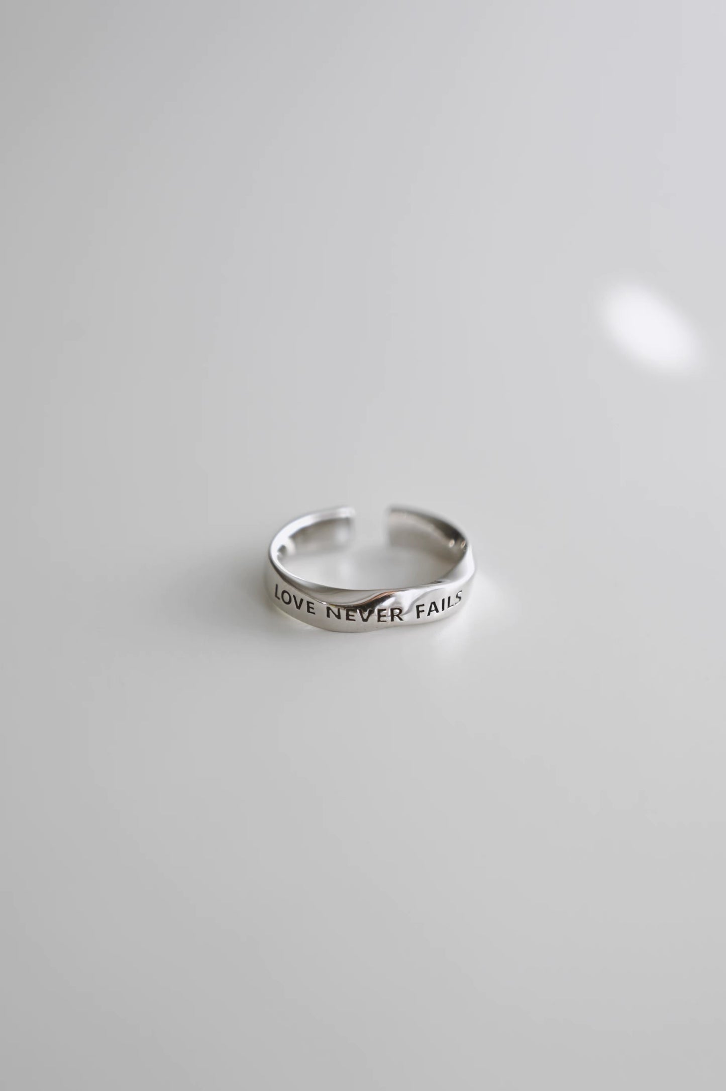 LOVE NEVER FAILS Silver-Plated Platinum Ring – Unique Design