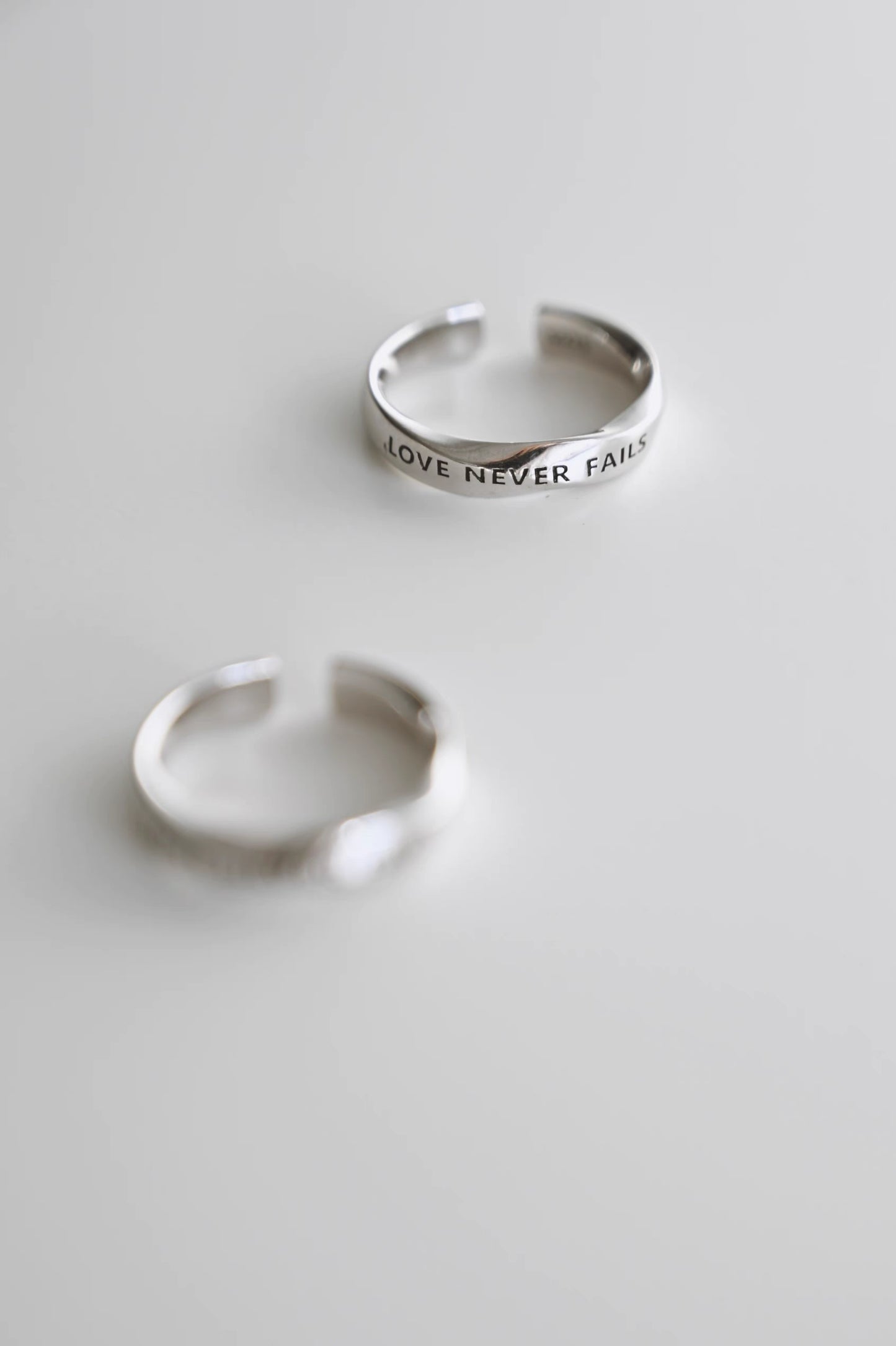 LOVE NEVER FAILS Silver-Plated Platinum Ring – Unique Design